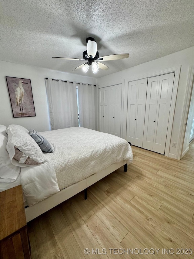 449734 E 356th Rd, Afton, OK 74331 - bedroom with two closets, light wood finished floors, a textured ceiling, and ceiling fan