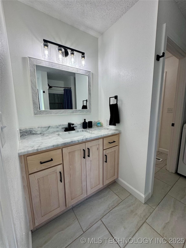 449734 E 356th Rd, Afton, OK 74331 - full bath with a textured ceiling, vanity, and baseboards