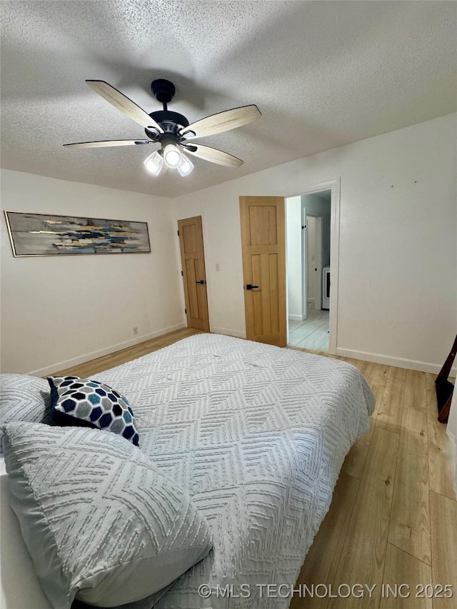 449734 E 356th Rd, Afton, OK 74331 - bedroom featuring light wood finished floors, baseboards, a textured ceiling, and a ceiling fan