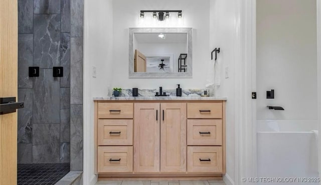 449734 E 356th Rd, Afton, OK 74331 - bathroom with a tile shower, a ceiling fan, and vanity