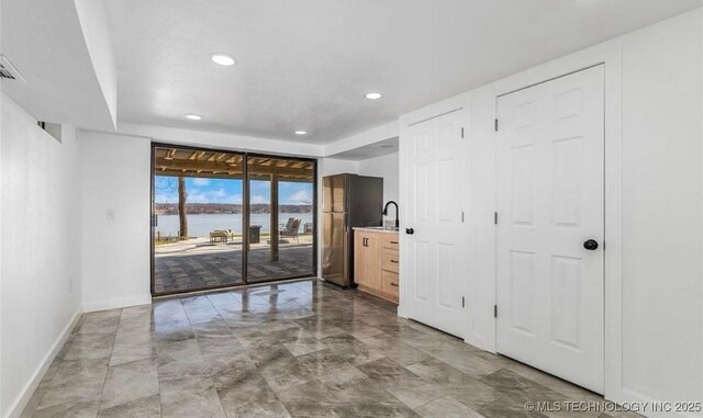 449734 E 356th Rd, Afton, OK 74331 - empty room with baseboards, recessed lighting, and a water view