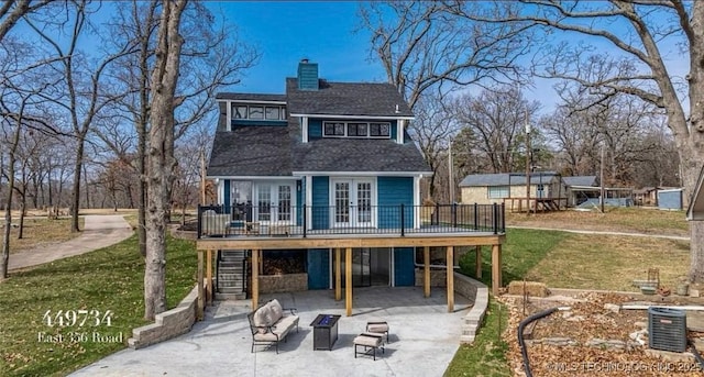 449734 E 356th Rd, Afton, OK 74331 - back of property featuring french doors, a wooden deck, a patio area, a yard, and a chimney