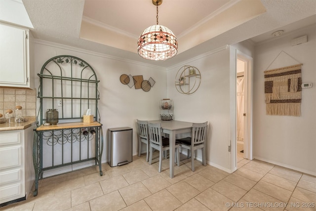 6353 S 80th E Ave Unit 1A, Tulsa, OK 74133 - dining area featuring a raised ceiling, a chandelier, light tile patterned floors, ornamental molding, and baseboards