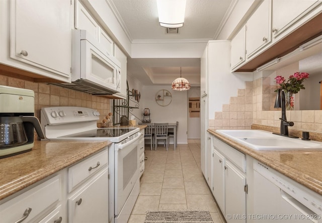 6353 S 80th E Ave Unit 1A, Tulsa, OK 74133 - kitchen featuring white appliances, a sink, decorative backsplash, white cabinets, and light countertops
