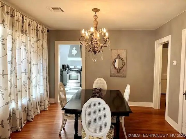 1124 W Elm, Durant, OK 74701 - dining space featuring a chandelier, wood finished floors, and baseboards
