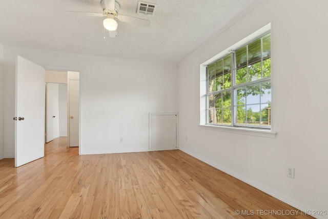 9590 S 4240th Rd, Chelsea, OK 74016 - unfurnished room featuring a textured ceiling, light wood-style flooring, a ceiling fan, and baseboards