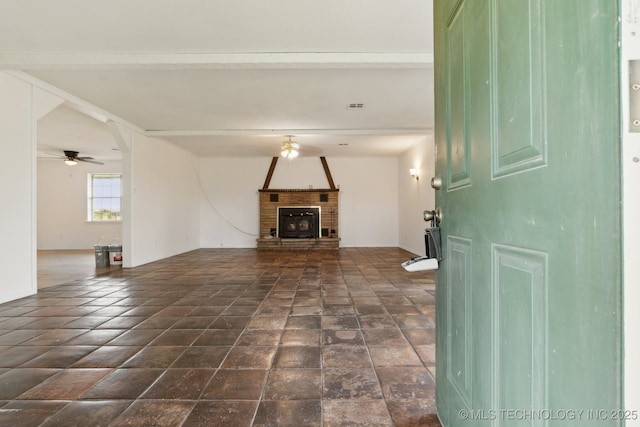 9590 S 4240th Rd, Chelsea, OK 74016 - unfurnished living room featuring a fireplace and a ceiling fan