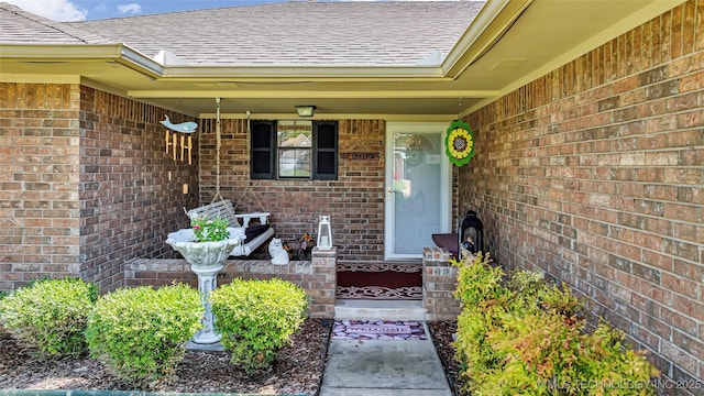 1902 NW 8th Ave, Ardmore, OK 73401 - entrance to property featuring a shingled roof, brick siding, and a porch