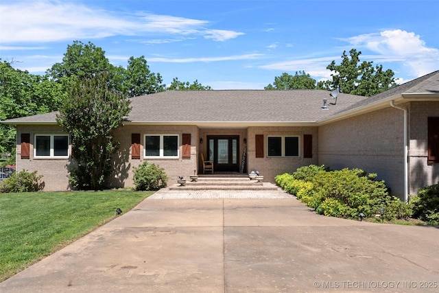 59144 E 290th Rd, Grove, OK 74344 - single story home with brick siding, a front yard, french doors, and a shingled roof