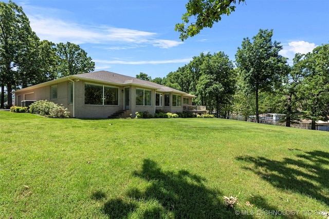 59144 E 290th Rd, Grove, OK 74344 - view of side of property with a yard, an attached garage, and stucco siding