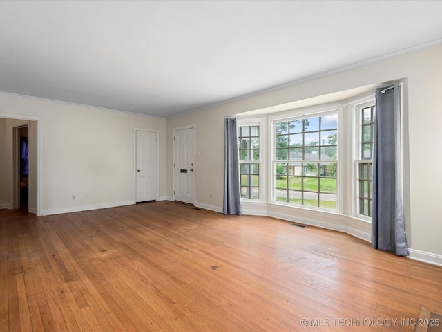 1724 Cherokee Pl, Bartlesville, OK 74003 - empty room with light wood finished floors, baseboards, and crown molding