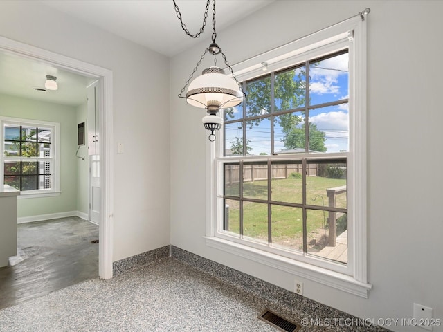 1724 Cherokee Pl, Bartlesville, OK 74003 - unfurnished dining area with plenty of natural light and baseboards