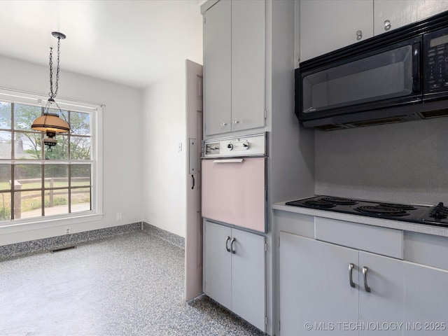 1724 Cherokee Pl, Bartlesville, OK 74003 - kitchen featuring black appliances, speckle patterned floor, pendant lighting, and light countertops