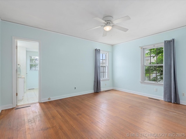 1724 Cherokee Pl, Bartlesville, OK 74003 - spare room featuring healthy amount of natural light, ceiling fan, light wood-style flooring, and baseboards