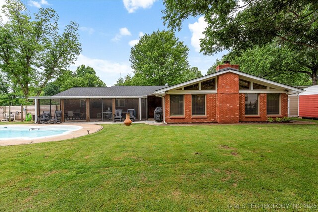 11837 S 84th Ave E, Bixby, OK 74008 - rear view of house with brick siding, a chimney, a sunroom, and a patio