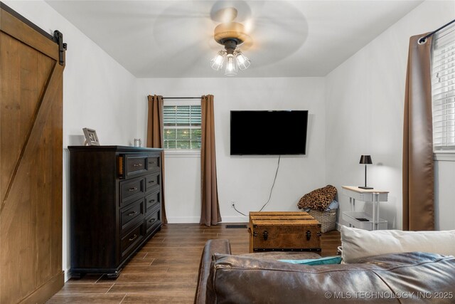 11837 S 84th Ave E, Bixby, OK 74008 - bedroom with dark wood-style floors, a barn door, baseboards, and a ceiling fan