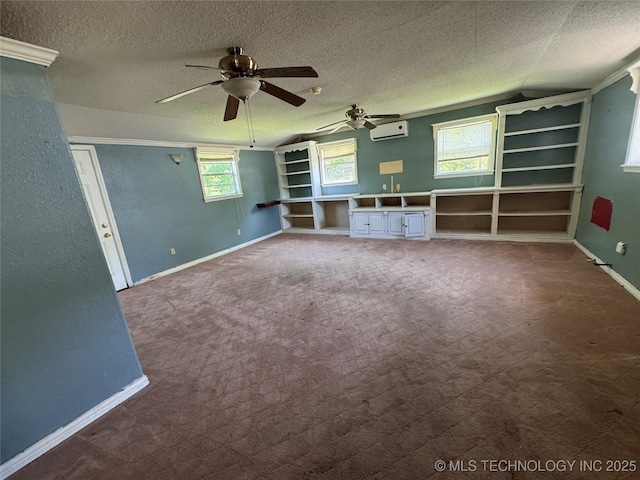 31206 E 683rd St, Wagoner, OK 74467 - unfurnished living room with a wall unit AC, a textured ceiling, ceiling fan, baseboards, and ornamental molding