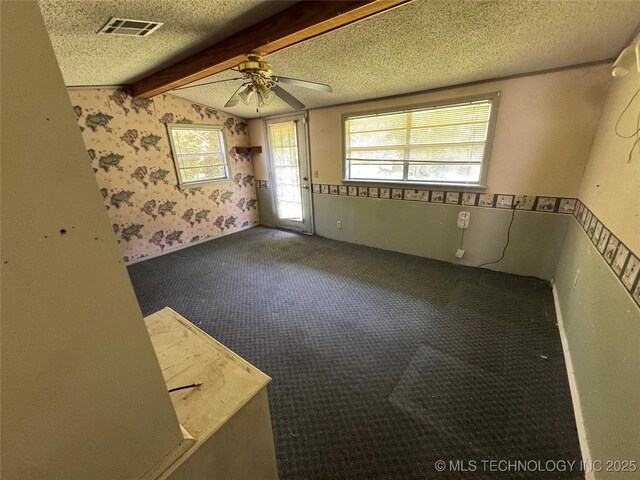 31206 E 683rd St, Wagoner, OK 74467 - spare room with ceiling fan, carpet floors, a textured ceiling, and wallpapered walls