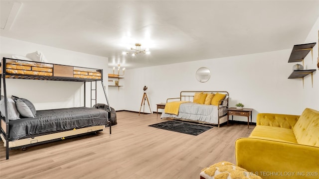2014 12th Ave NW, Ardmore, OK 73401 - bedroom featuring wood finished floors and a chandelier