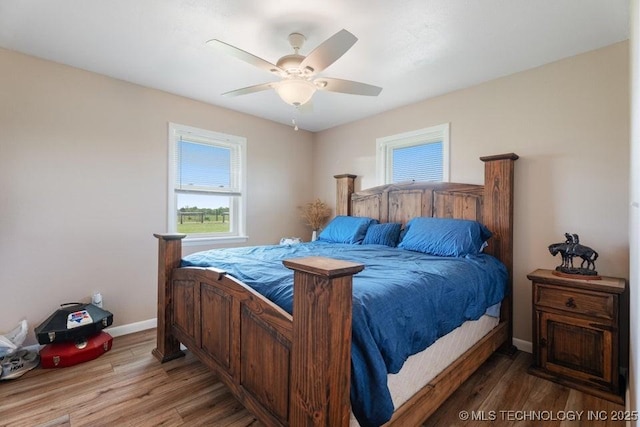 24708 E 18th Rd, Vinita, OK 74301 - bedroom with baseboards, wood finished floors, and a ceiling fan