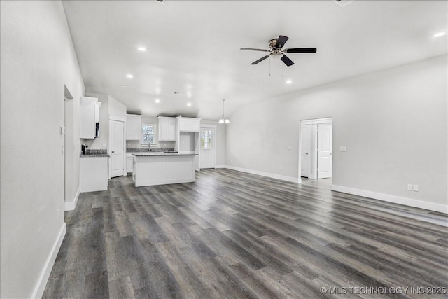 345 Kats, Durant, OK 74701 - unfurnished living room featuring ceiling fan, dark wood-style floors, baseboards, and recessed lighting