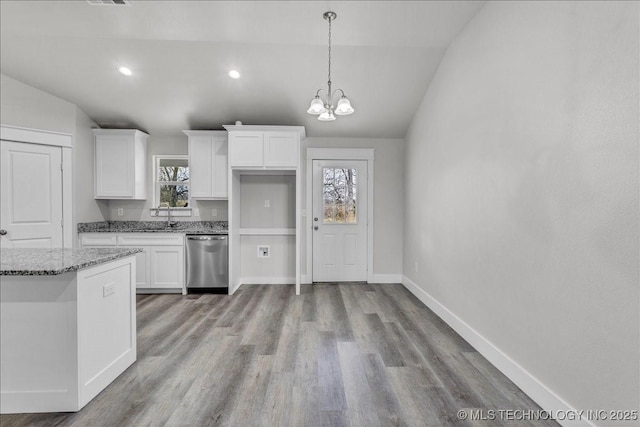 345 Kats, Durant, OK 74701 - kitchen with stainless steel dishwasher, white cabinets, a sink, light wood finished floors, and a chandelier