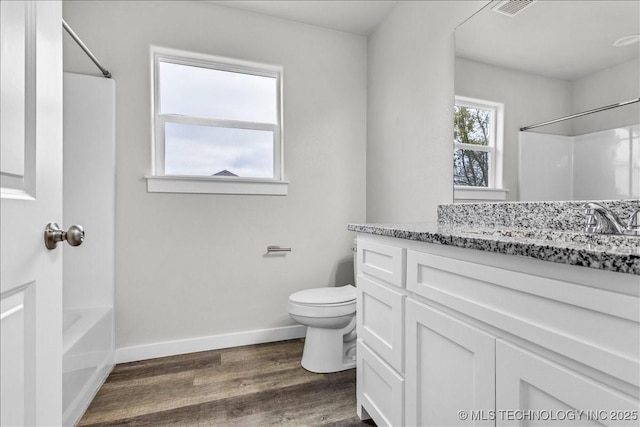 345 Kats, Durant, OK 74701 - full bath featuring wood finished floors, toilet, baseboards, vanity, and  shower combination
