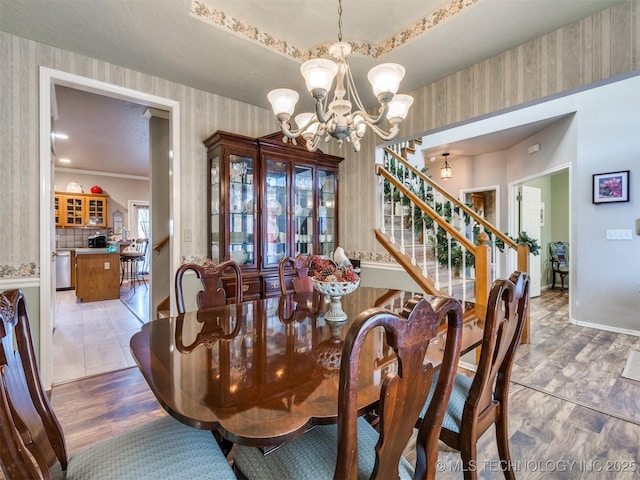 1821 N 11th St, Broken Arrow, OK 74012 - dining area with wallpapered walls, a chandelier, and stairs