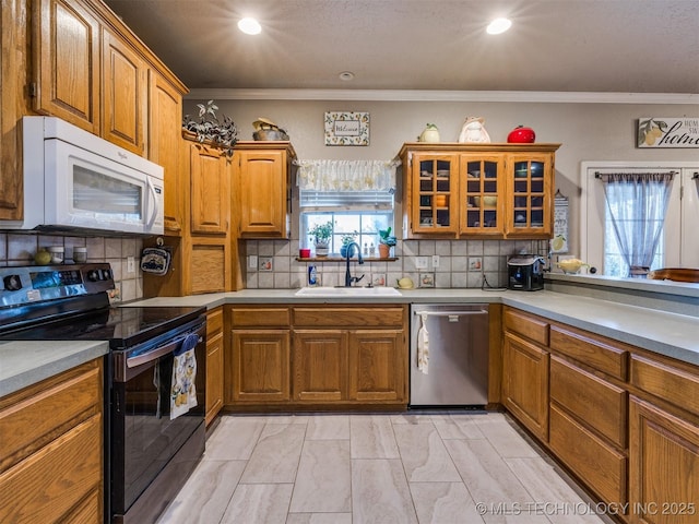 1821 N 11th St, Broken Arrow, OK 74012 - kitchen with white microwave, black electric range oven, stainless steel dishwasher, a sink, and brown cabinets