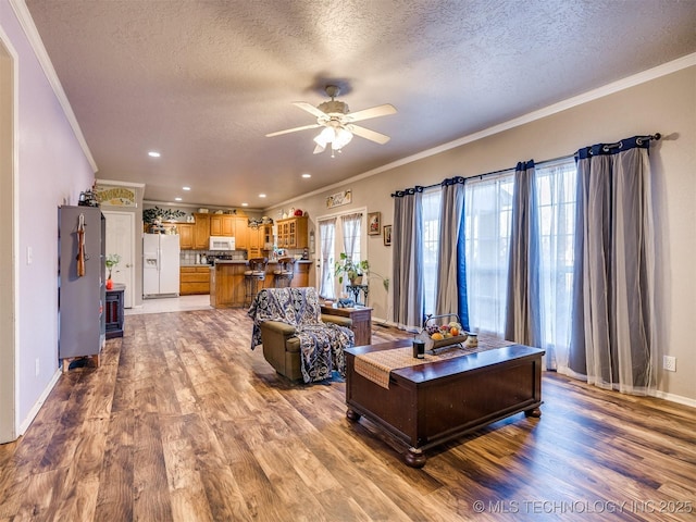 1821 N 11th St, Broken Arrow, OK 74012 - living area with a textured ceiling, ornamental molding, wood finished floors, a ceiling fan, and baseboards