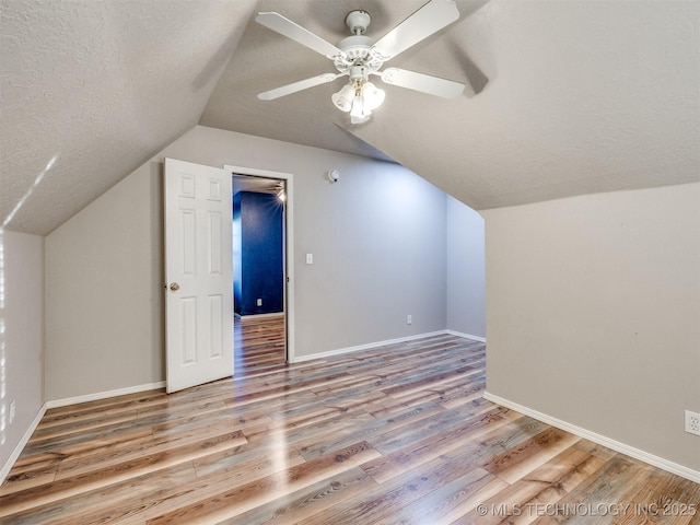 1821 N 11th St, Broken Arrow, OK 74012 - bonus room featuring vaulted ceiling, a textured ceiling, wood finished floors, baseboards, and ceiling fan