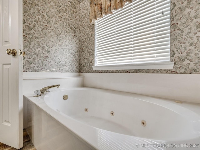 1821 N 11th St, Broken Arrow, OK 74012 - full bath featuring wallpapered walls, a whirlpool tub, and wood finished floors
