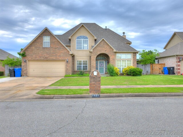 1821 N 11th St, Broken Arrow, OK 74012 - traditional-style house with brick siding, driveway, an attached garage, roof with shingles, and a chimney
