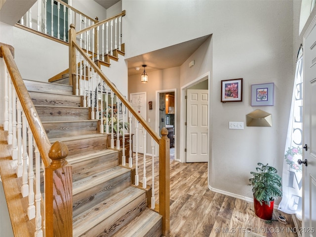 1821 N 11th St, Broken Arrow, OK 74012 - stairs featuring wood finished floors, baseboards, and a high ceiling