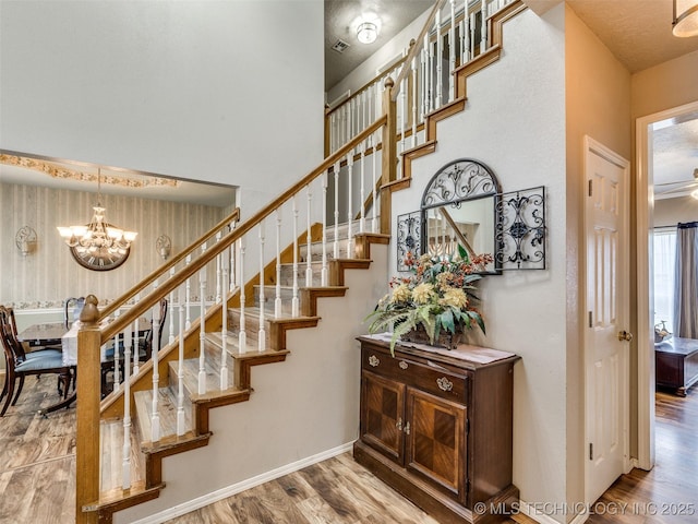 1821 N 11th St, Broken Arrow, OK 74012 - stairway featuring wood finished floors, a chandelier, and baseboards