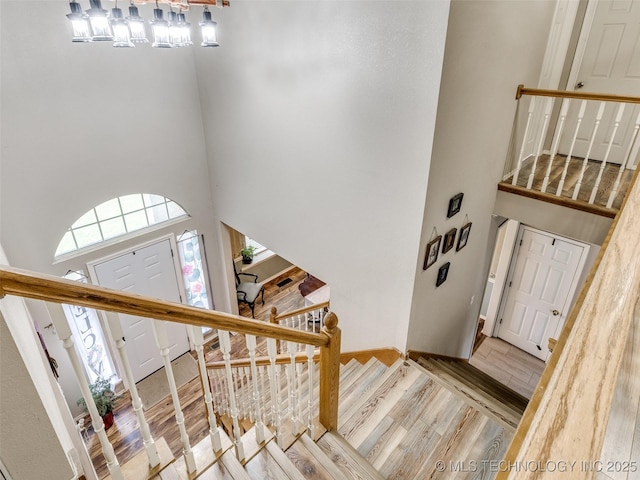 1821 N 11th St, Broken Arrow, OK 74012 - foyer featuring a high ceiling, stairway, wood finished floors, healthy amount of natural light, and a chandelier