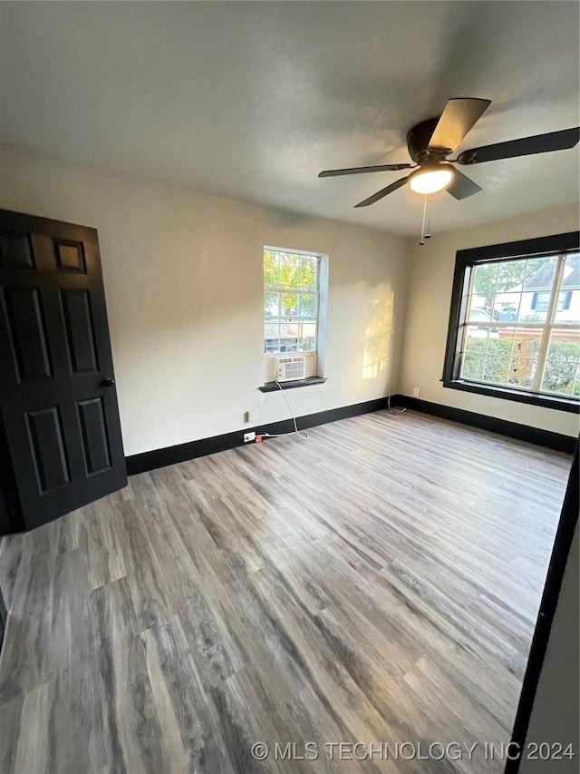 413 NW 11th Ave, Ardmore, OK 73401 - empty room with healthy amount of natural light, wood finished floors, baseboards, and ceiling fan