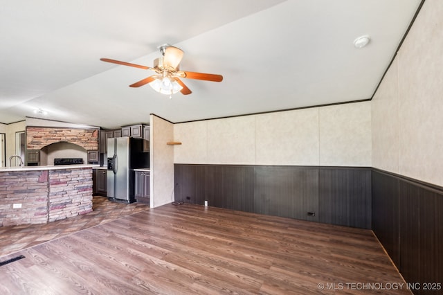 10180 S 241st W Ave, Sapulpa, OK 74066 - unfurnished living room with a ceiling fan, dark wood-style floors, lofted ceiling, wainscoting, and wooden walls
