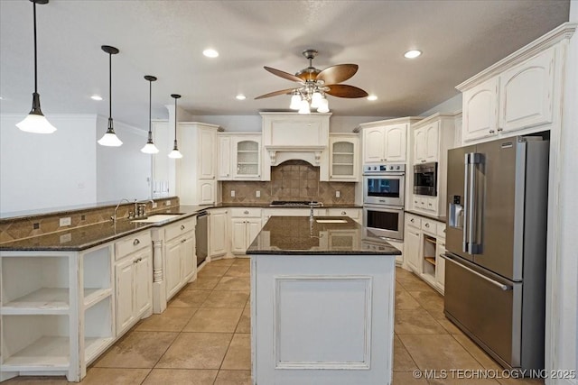 2259 E Rodeo Rd, Durant, OK 74701 - kitchen with stainless steel appliances, a peninsula, a ceiling fan, backsplash, and glass insert cabinets