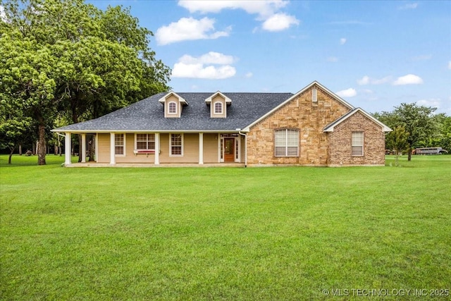 2259 E Rodeo Rd, Durant, OK 74701 - view of front of house with a front yard, roof with shingles, covered porch, and brick siding