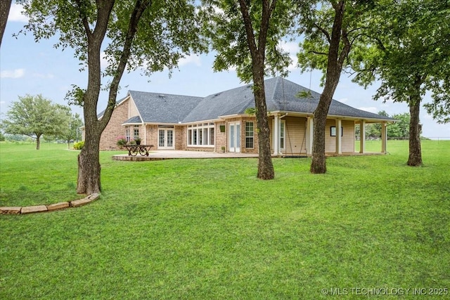 2259 E Rodeo Rd, Durant, OK 74701 - view of front of house with a front yard, a patio area, and french doors