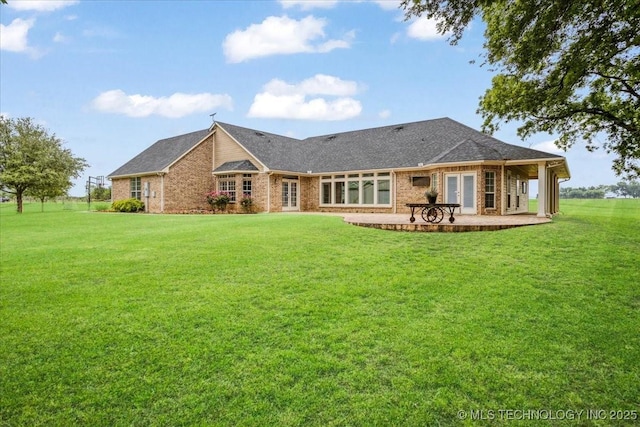 2259 E Rodeo Rd, Durant, OK 74701 - rear view of property with a lawn, brick siding, french doors, and a patio