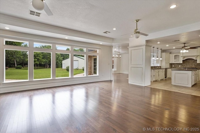2259 E Rodeo Rd, Durant, OK 74701 - unfurnished living room featuring a ceiling fan, light wood-style floors, a chandelier, a textured ceiling, and recessed lighting