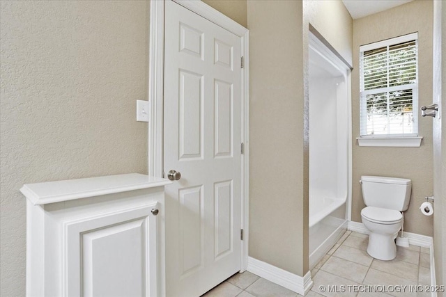 2259 E Rodeo Rd, Durant, OK 74701 - full bathroom featuring tile patterned floors, toilet, baseboards, and bathtub / shower combination