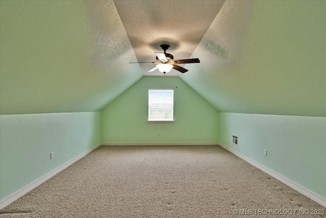 2259 E Rodeo Rd, Durant, OK 74701 - bonus room with a textured ceiling, a ceiling fan, lofted ceiling, carpet floors, and baseboards