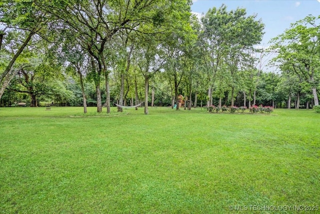 2259 E Rodeo Rd, Durant, OK 74701 - view of green lawn featuring a playground