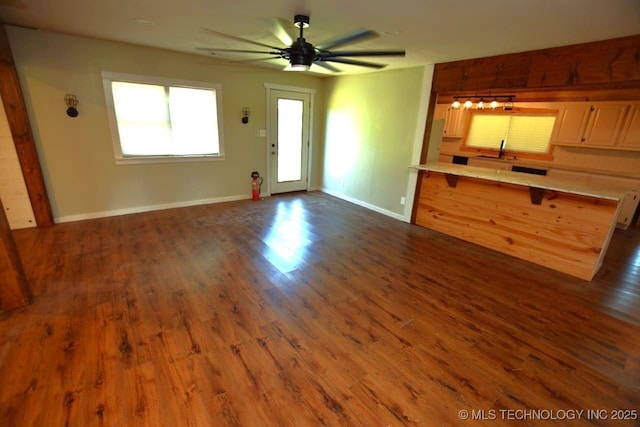 98926 S 4610th Rd, Marble City, OK 74945 - unfurnished living room featuring a sink, dark wood-type flooring, ceiling fan, and baseboards