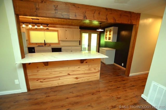 98926 S 4610th Rd, Marble City, OK 74945 - kitchen featuring a peninsula, white cabinetry, a breakfast bar, and dark wood-style floors