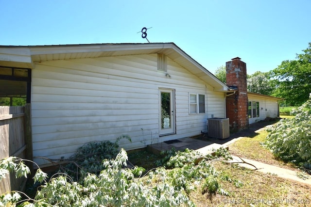 98926 S 4610th Rd, Marble City, OK 74945 - rear view of house featuring central AC unit and a chimney