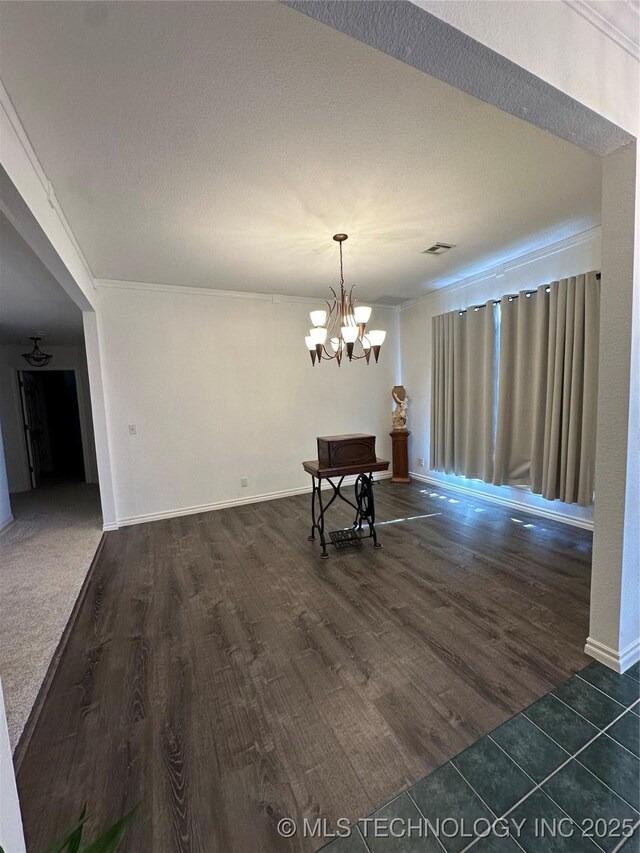 7604 N 127th E Ave, Owasso, OK 74055 - dining area featuring dark wood-style flooring, a chandelier, and baseboards